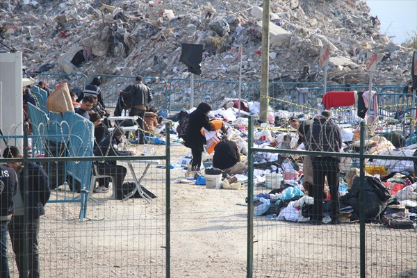 Enkaz döküm alanındaki eşyaların arasında depremde ölen yakınlarının hatıralarını arıyorlar